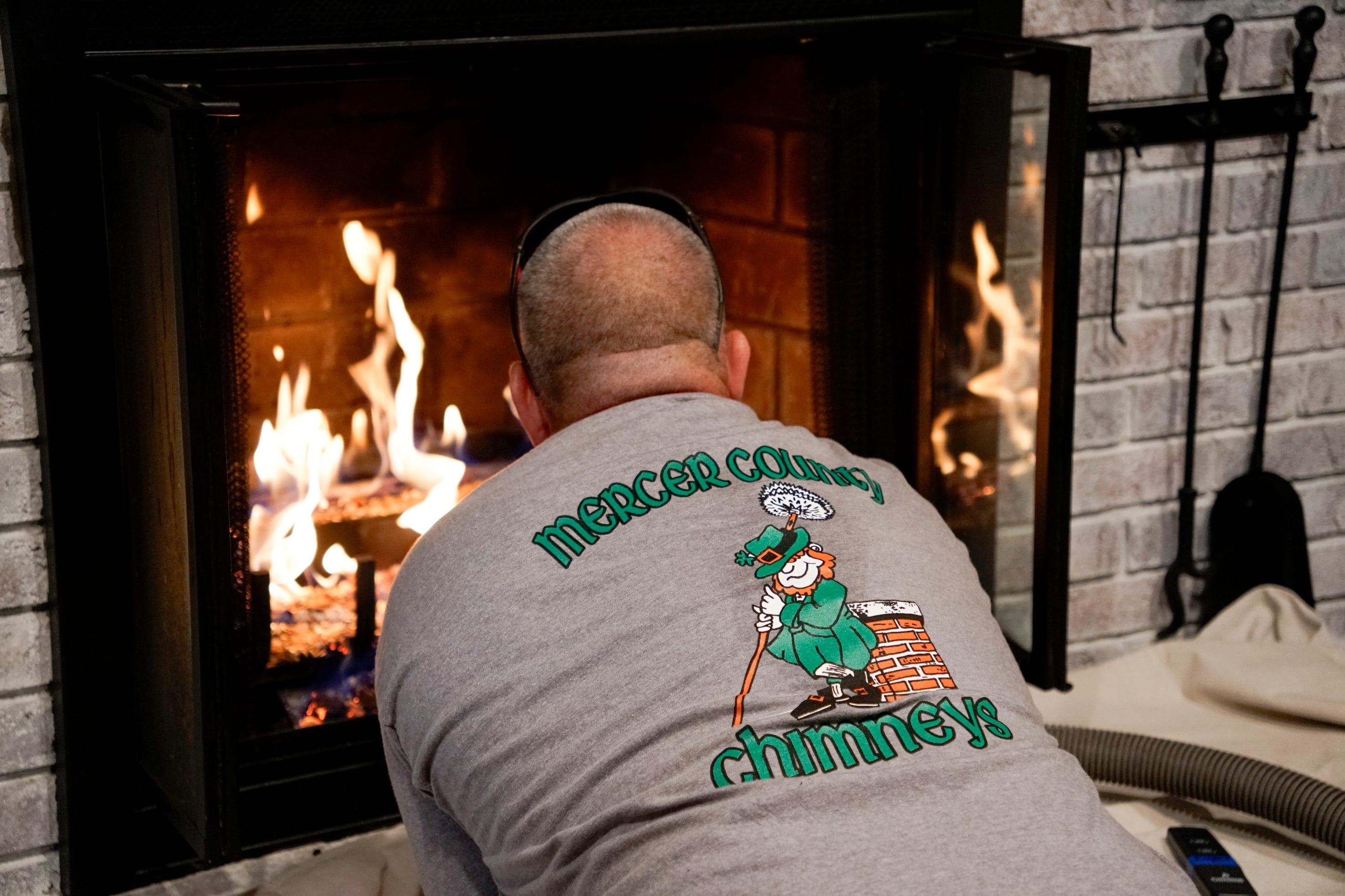 Original image of a Mercer County Chimney Services tech testing a fireplace.