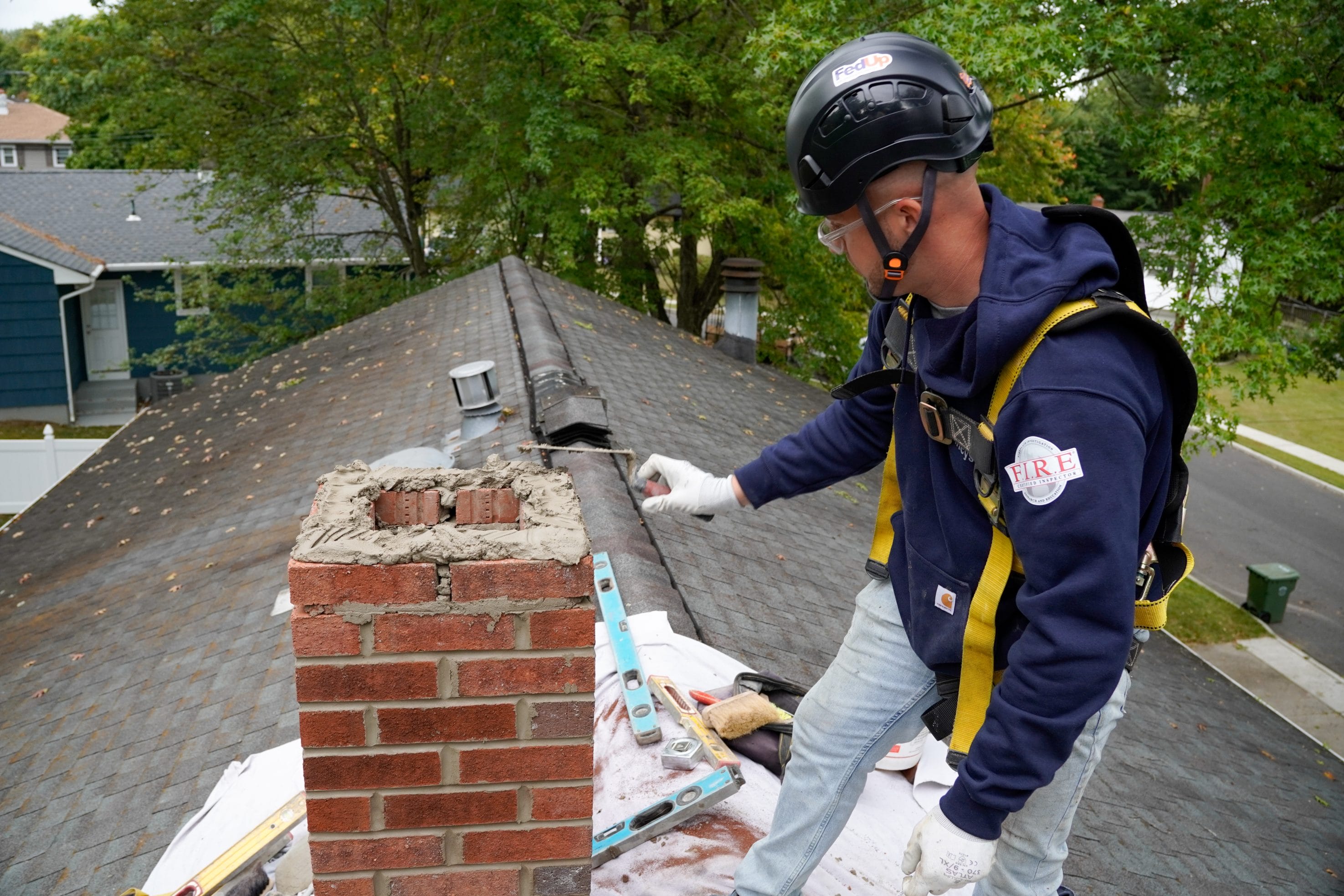 Original image of tech working on chimney masonry by Mercer County Chimney Services.